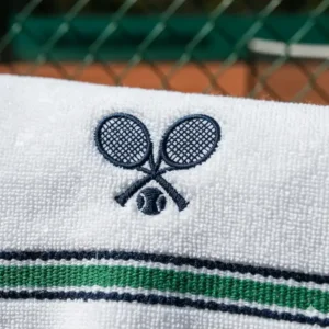Detail shot of an embroidered logo on a high-quality tennis towel, ideal for teams or gifts.