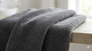 Close-up macro shot showing the soft, dense texture and pile of a velour bath towel.