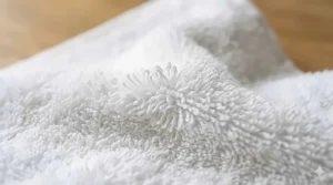 Close-up detail of the absorbent cotton loops on a traditional terry cloth bath towel.
