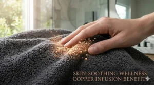 Illustration of a hand touching soft towel fabric, with glowing copper ions visually soothing and refreshing the skin surface.